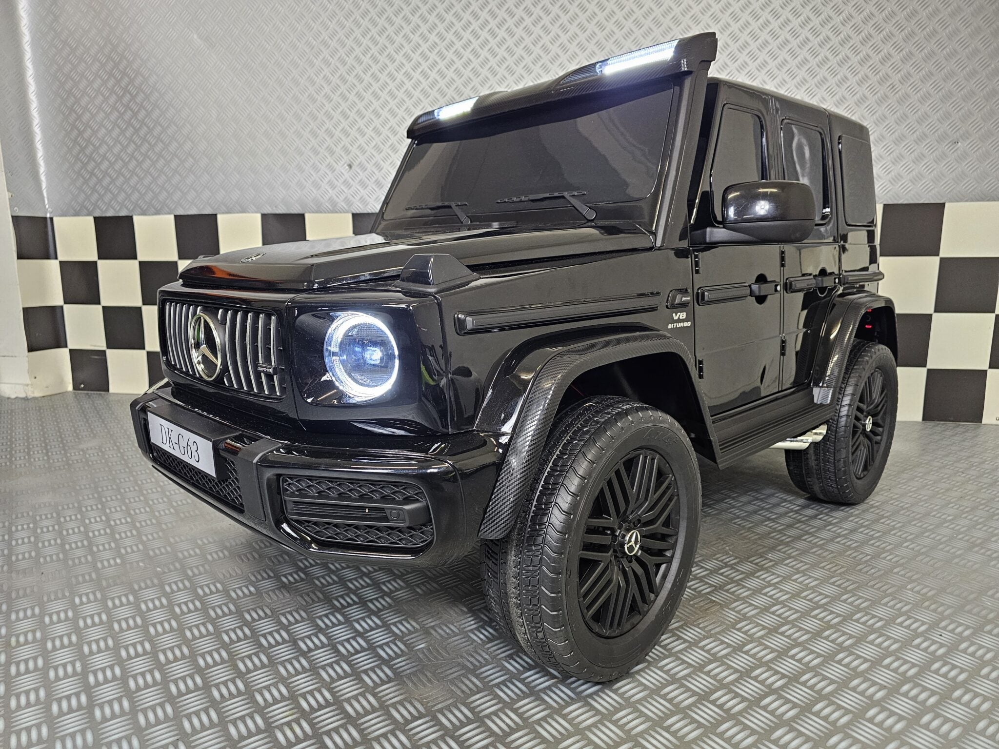 Elektrische kinderauto Mercedes G63 AMG 4×4 24 volt 2-persoons metallic zwart